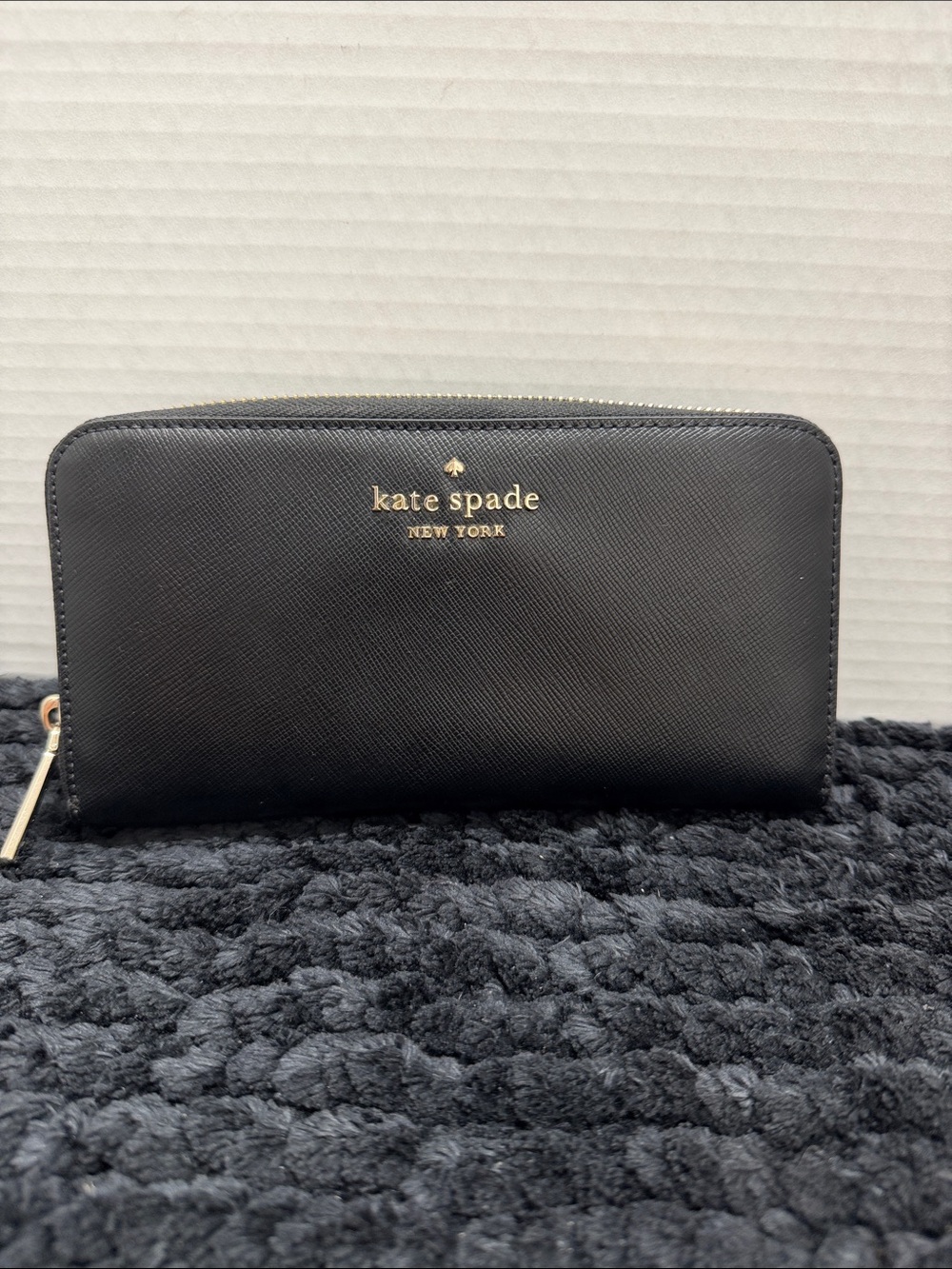 kate spade black zip-around saffiano wallet with gold logo